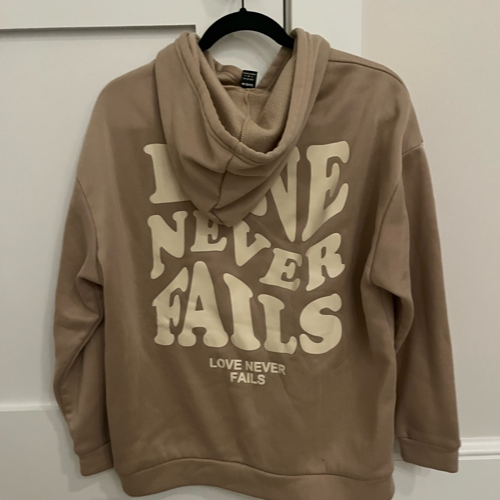 Love never fails hoodie